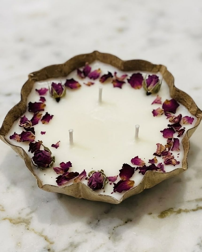 Dried rose petals around a lotus urli candle