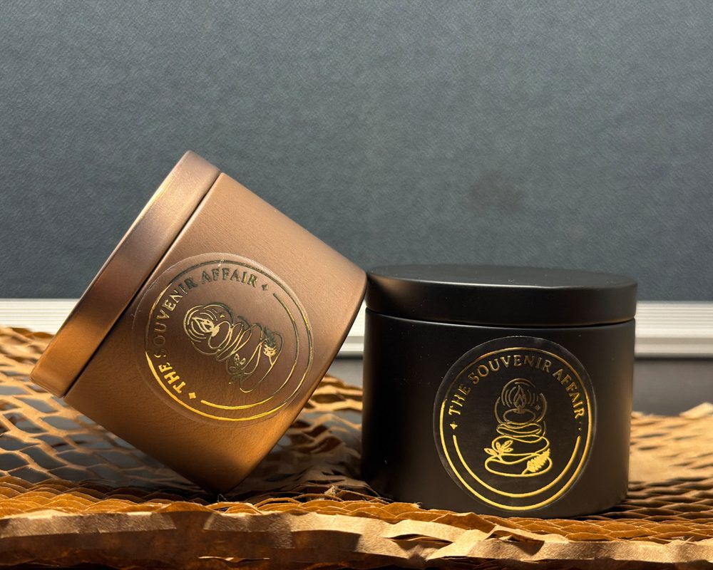 Two sealed tin candles on gift paper