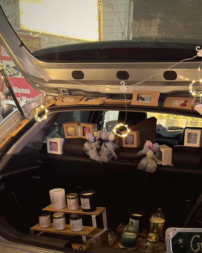 Boxed candles and tulip candle bouquets along the back seats, under fairy lights