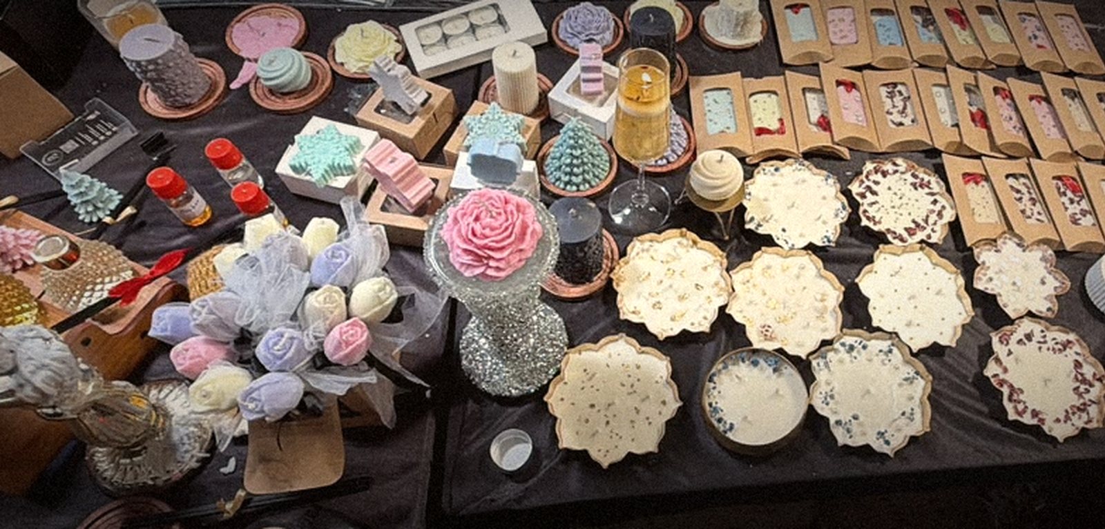 The full stall table seen from above: lotus urlis, jars, bell jars and wax sachets